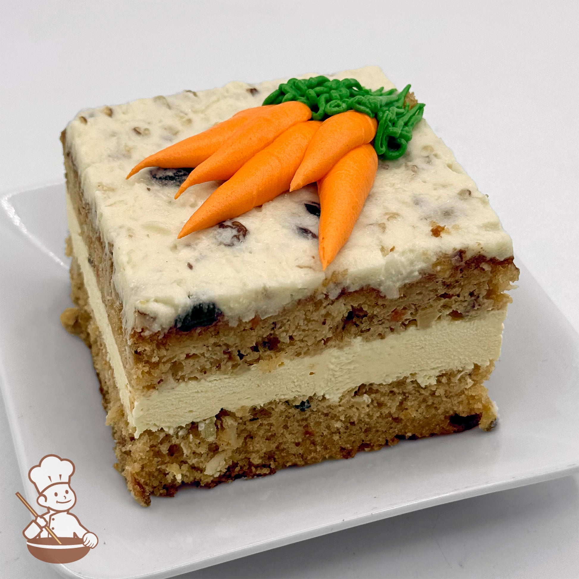 A slice of carrot cake with cream cheese icing, topped with decorative buttercream carrots and green leaves.