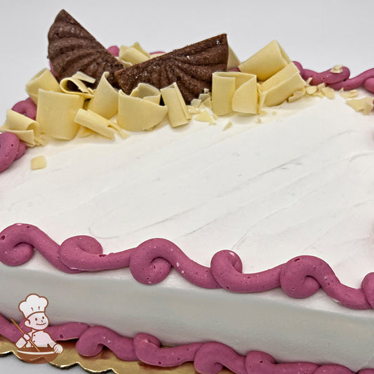 Sheet cake with white chocolate curls and chocolate shortbread cookies.