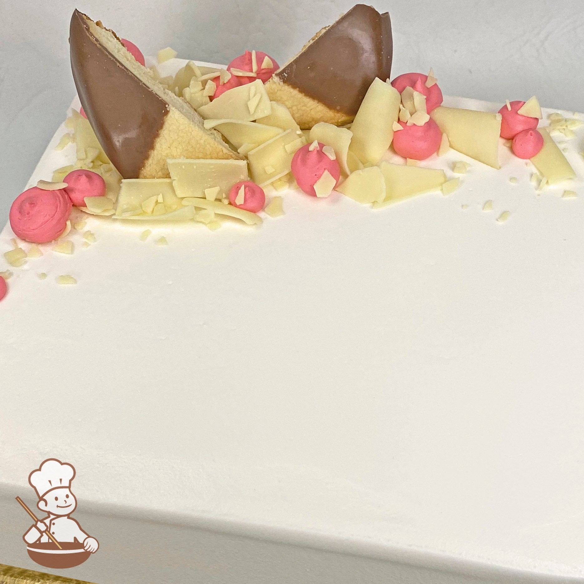 Sheet cake with white chocolate curls and chocolate dipped shortbread cookies with buttercream dollops.