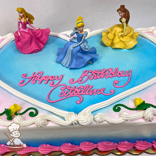 Sheet cake with a buttercream heart, featuring plastic toys of Aurora, Cinderella, and Belle. Decorated with yellow buttercream roses.