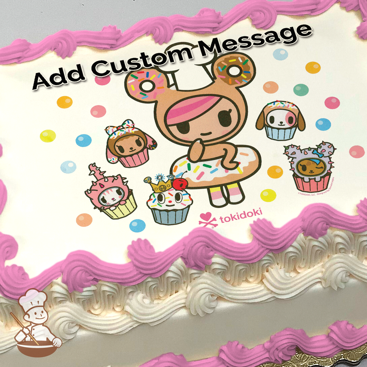 Illustration of a cartoon character resembling a girl with donut ears, surrounded by cupcakes with cute faces, printed on a sheet cake.