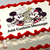 Mickey and Minnie Mouse holding hands with a Parisian street scene background, printed on a sheet cake.