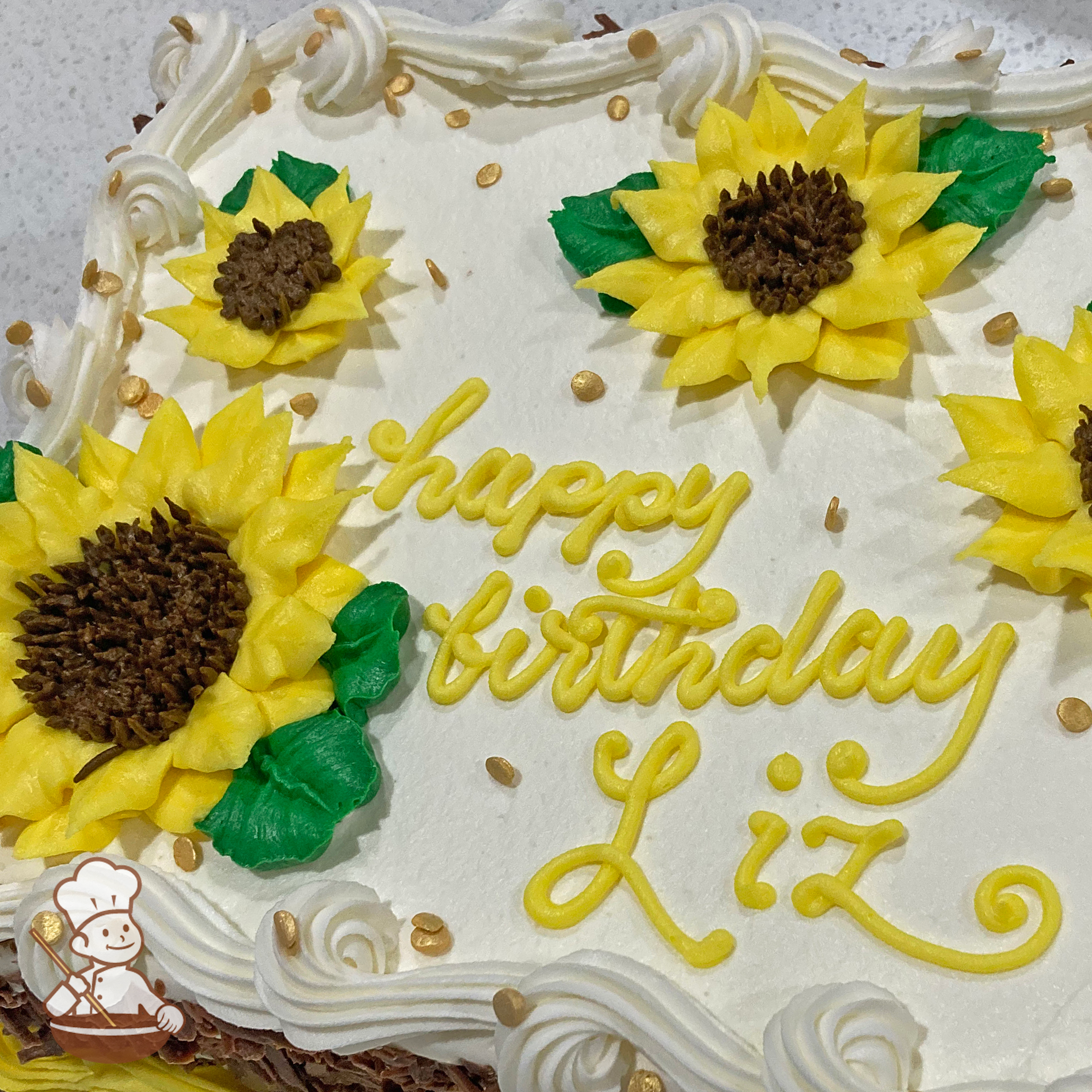 Birthday sheet cake with white fence behind vegetable garden filled tomatoes, lettuce, carrots and potatoes.