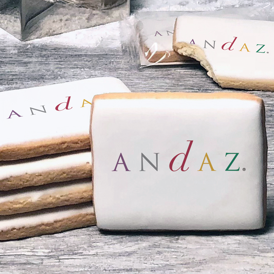 A stack of rectangle butter shortbread cookies with Andaz logo printed directly on a white, lemon sugar icing.