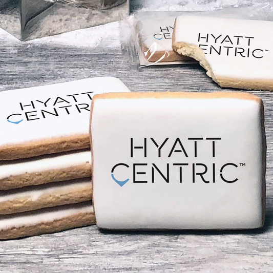 A stack of rectangle butter shortbread cookies with Hyatt Centric logo printed directly on a white, lemon sugar icing.