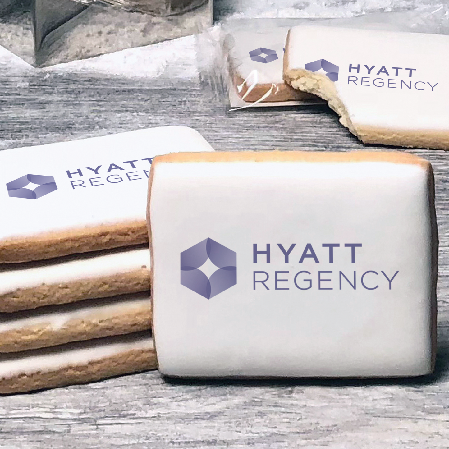 A stack of rectangle butter shortbread cookies with Hyatt Regency logo printed directly on a white, lemon sugar icing.