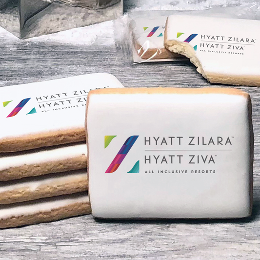 A stack of rectangle butter shortbread cookies with Hyatt Zilara logo printed directly on a white, lemon sugar icing.