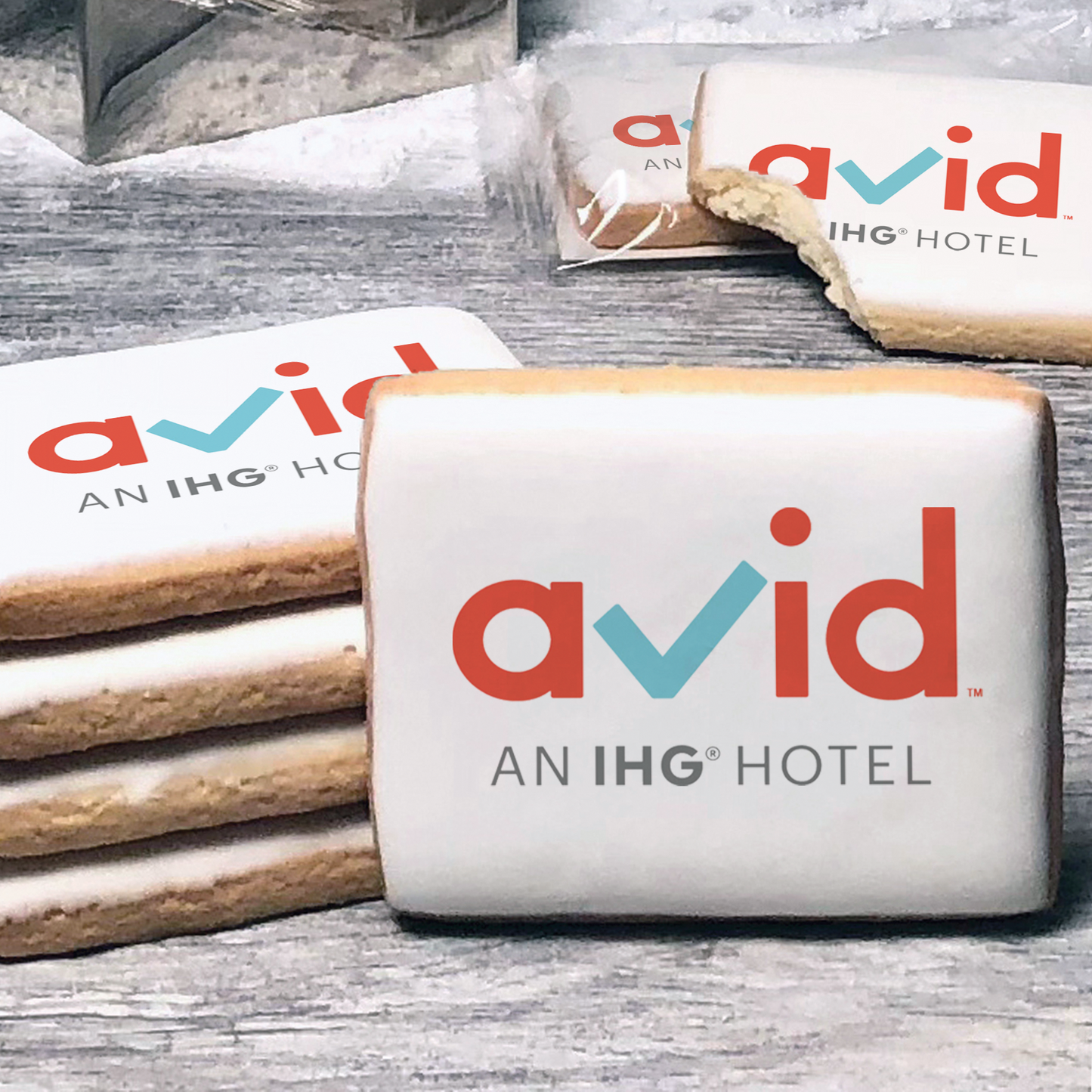 A stack of rectangle butter shortbread cookies with Avid logo printed directly on a white, lemon sugar icing.