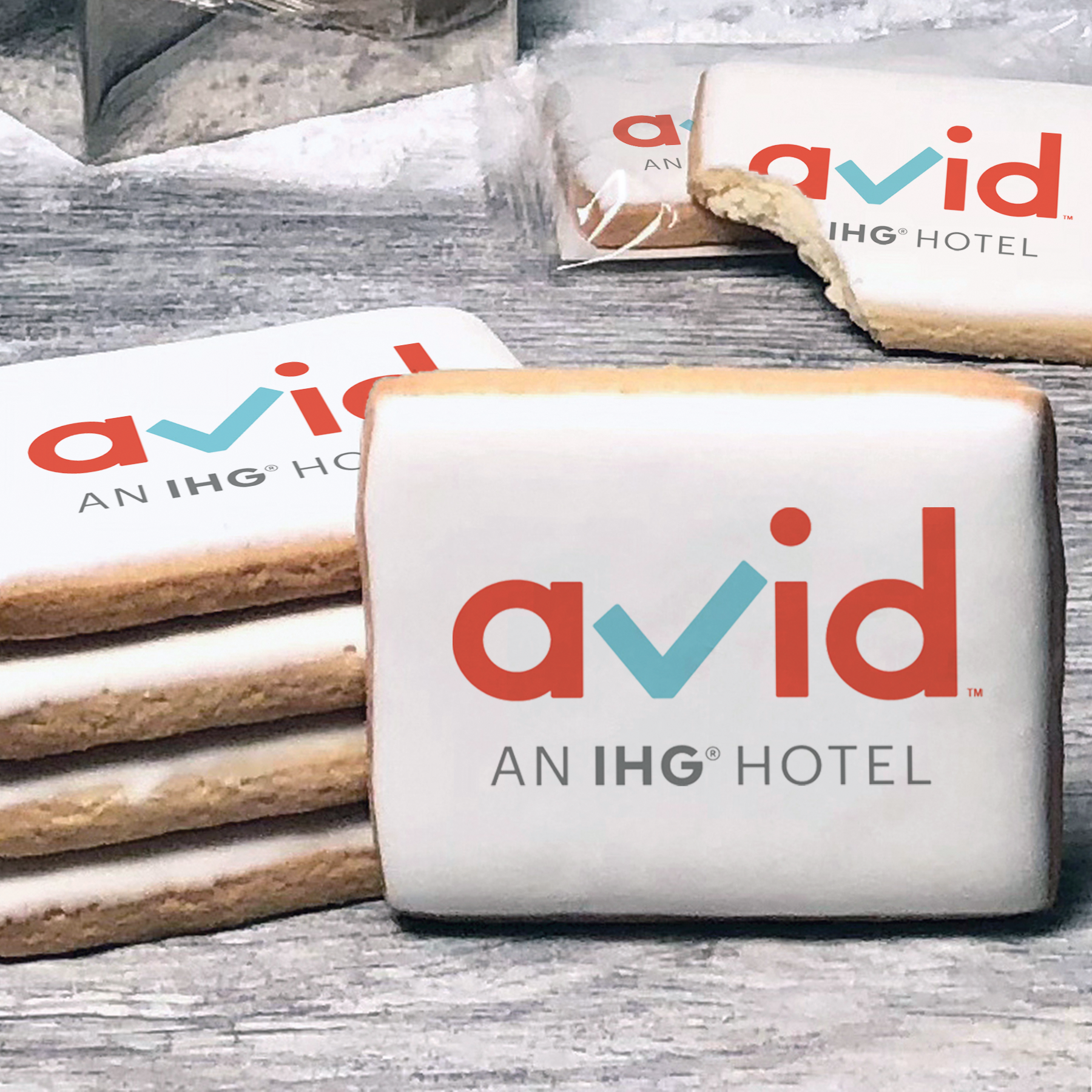 A stack of rectangle butter shortbread cookies with Avid logo printed directly on a white, lemon sugar icing.