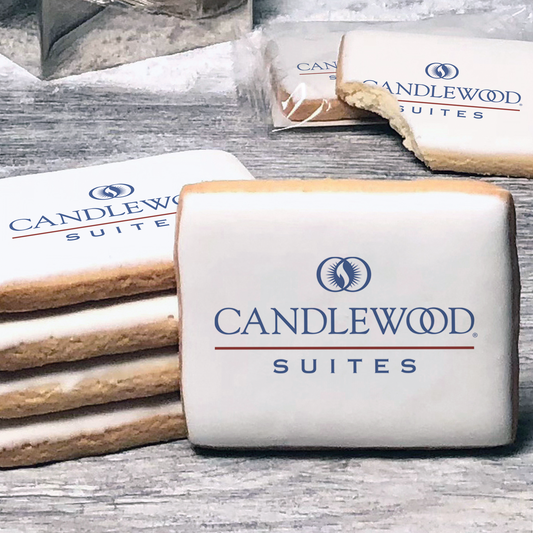 A stack of rectangle butter shortbread cookies with Candlewood Suites logo printed directly on a white, lemon sugar icing.