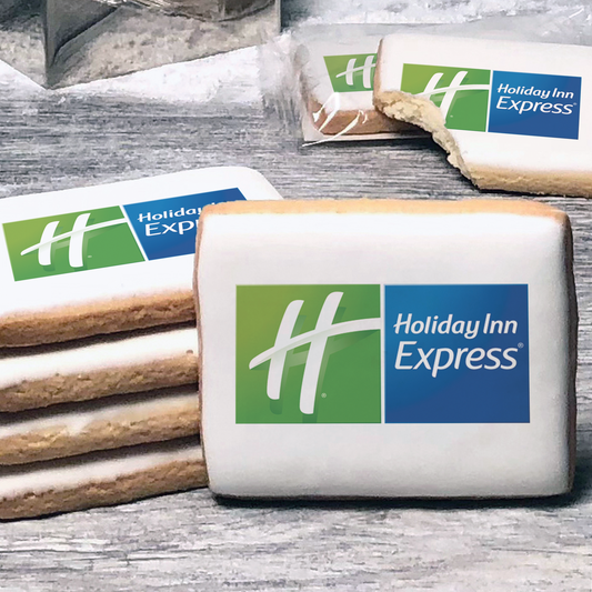 A stack of rectangle butter shortbread cookies with Holiday Inn Express logo printed directly on a white, lemon sugar icing.