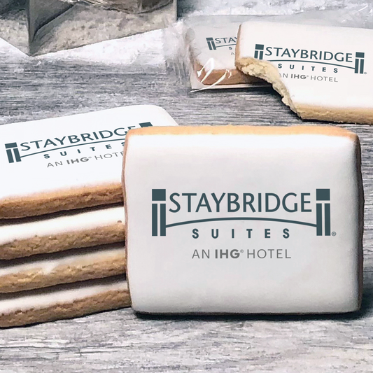 A stack of rectangle butter shortbread cookies with Staybridge Suites logo printed directly on a white, lemon sugar icing.