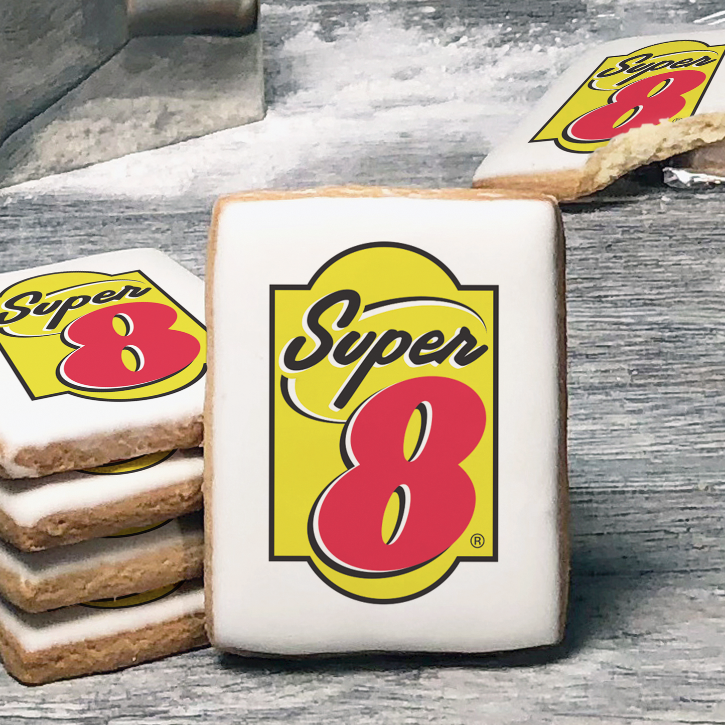 A stack of rectangle butter shortbread cookies with Super 8 logo printed directly on a white, lemon sugar icing.