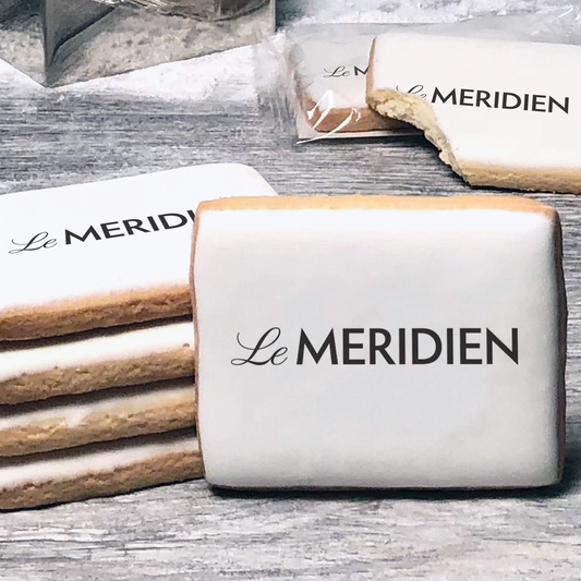 A stack of rectangle butter shortbread cookies with Le Meridien logo printed directly on a white, lemon sugar icing.