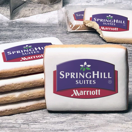 A stack of rectangle butter shortbread cookies with Springhill Suites logo printed directly on a white, lemon sugar icing.