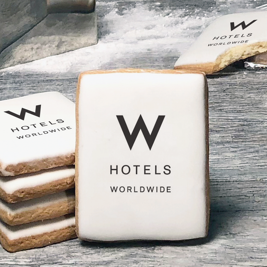 A stack of rectangle butter shortbread cookies with W Hotels logo printed directly on a white, lemon sugar icing.