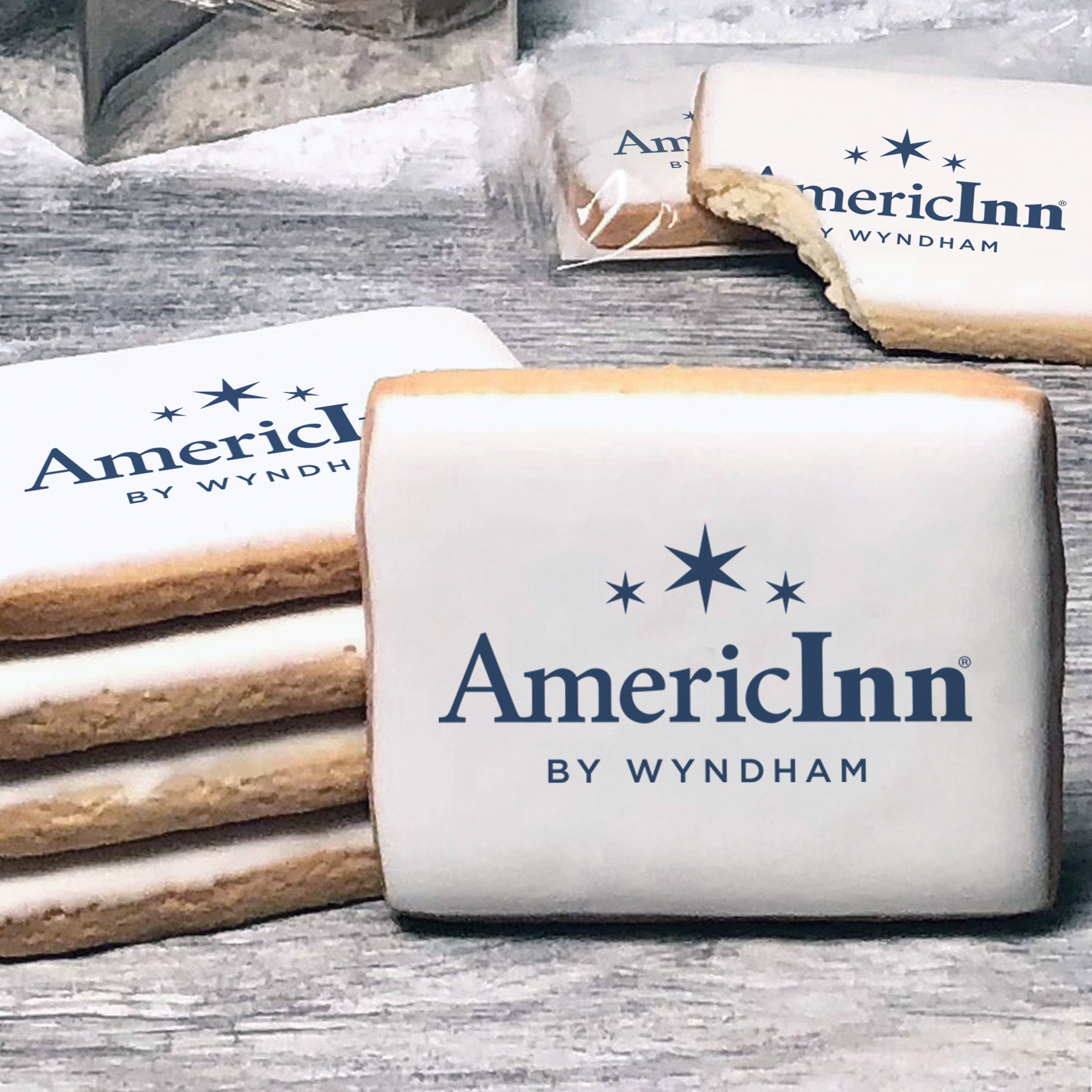 A stack of rectangle butter shortbread cookies with AmericInn logo printed directly on a white, lemon sugar icing.