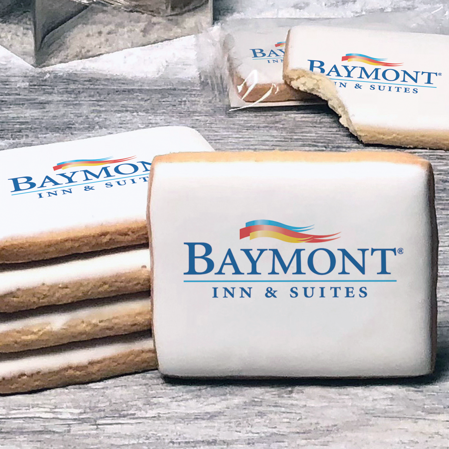 A stack of rectangle butter shortbread cookies with Baymont logo printed directly on a white, lemon sugar icing.