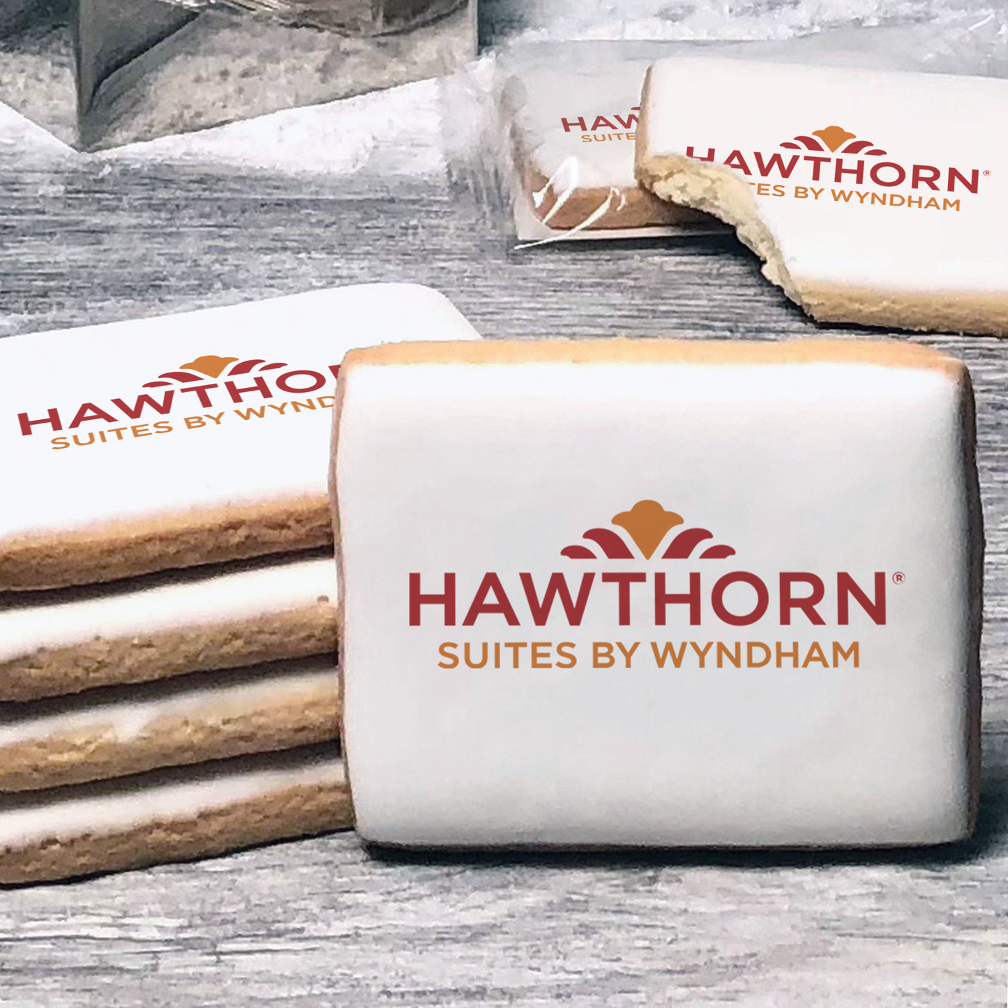 A stack of rectangle butter shortbread cookies with Hawthorn logo printed directly on a white, lemon sugar icing.