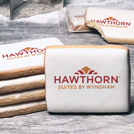 A stack of rectangle butter shortbread cookies with Hawthorn logo printed directly on a white, lemon sugar icing.