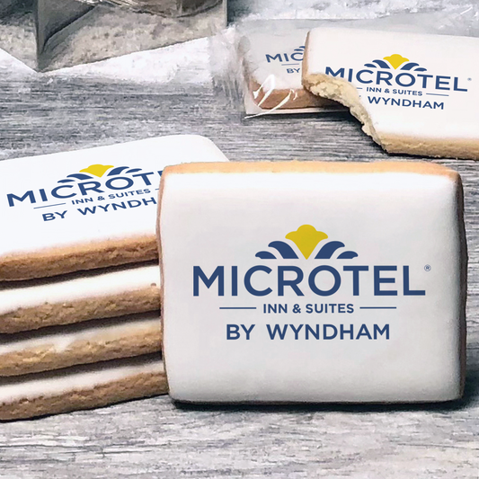 A stack of rectangle butter shortbread cookies with Microtel logo printed directly on a white, lemon sugar icing.