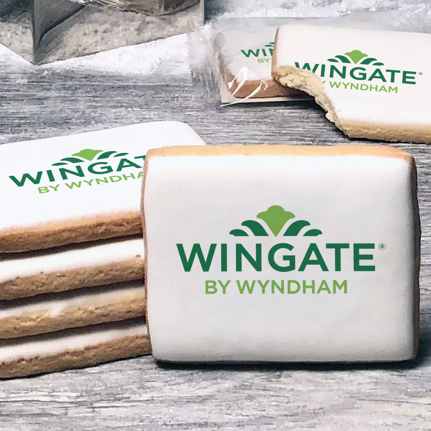 A stack of rectangle butter shortbread cookies with Wingate by Wyndham logo printed directly on a white, lemon sugar icing.