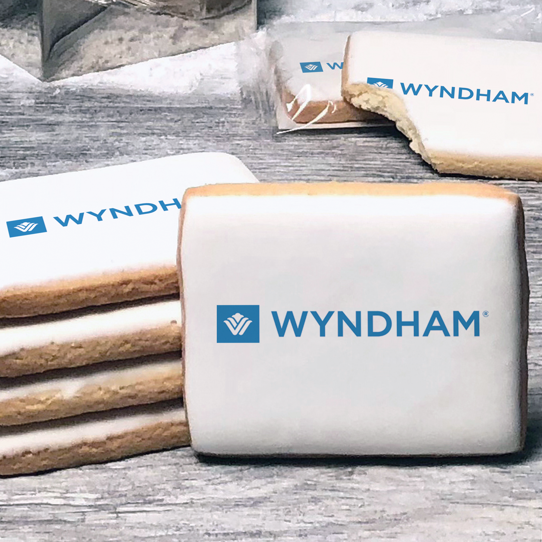 A stack of rectangle butter shortbread cookies with Wyndham logo printed directly on a white, lemon sugar icing.