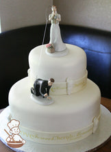 2 tier round offset fondant cake with custom printed fondant band on base of each tier with fondant seashells.