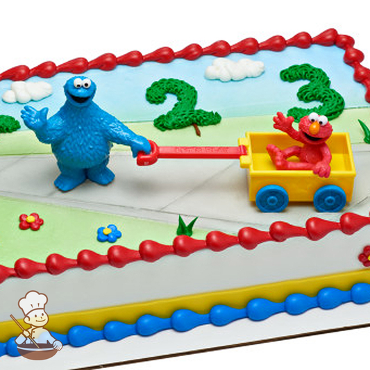 Birthday sheet cake with Sesame Street Elmo and Cookie Monster toy.